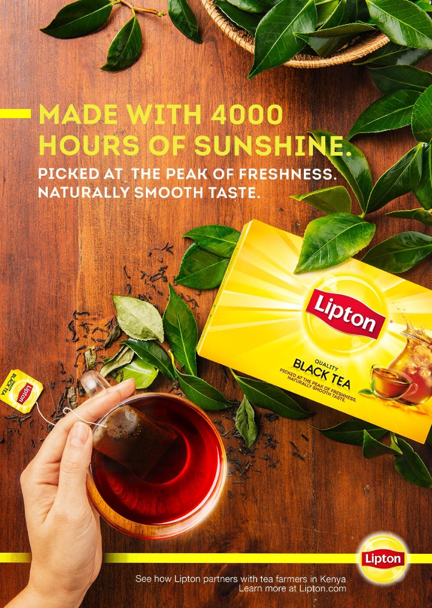 A color photo by Michael Marquand of a box of Lipton tea alongside of a cup of tea. 