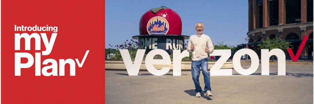 An image by Mo Daud of a man posing in front of the Verizon letters.