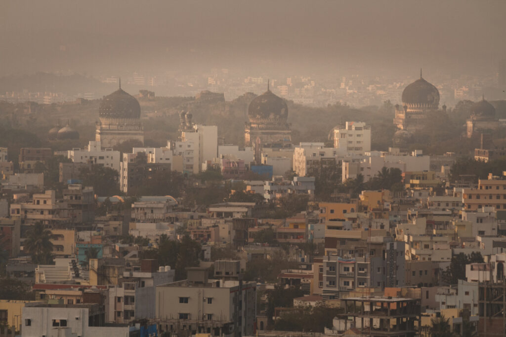 A panoramic shot of the sprawling urban landscape of an Indian city, revealing a tapestry of buildings that stretch to the horizon.