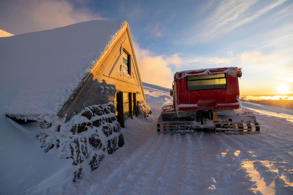 This image captures the idyllic Silcox Hut, with a sturdy Sno-Cat parked in front, image by Richard Darbonne.