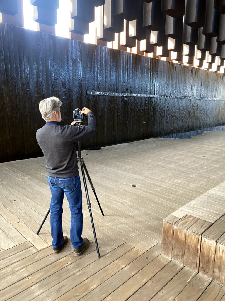 A behind-the-scenes shot captures Robert Rausch in action, skillfully capturing poignant moments at Montgomery's Sculpture Park.