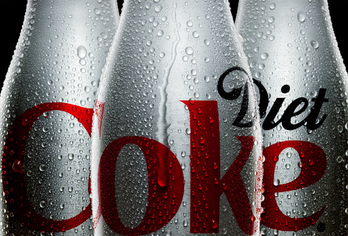 A color photograph by Satsoshi Kobabyshi of aluminum bottles of Diet Coke with condensation. 