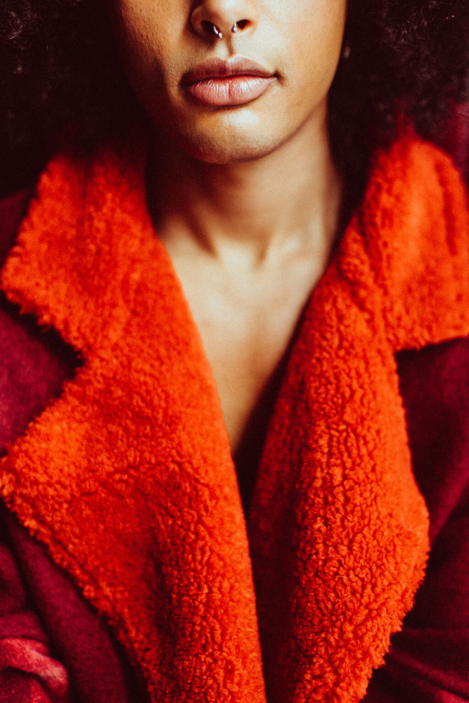 Closeup photo by Stephanie Bassos of a person wearing a bright red coat.