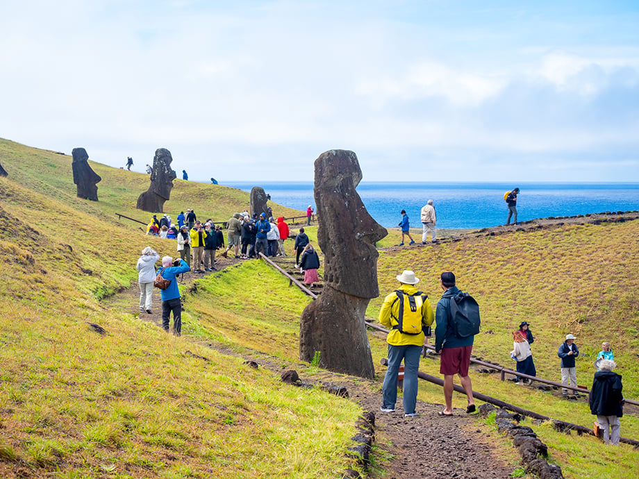 Group of tourists exploring Easter Island and the moai statues.
