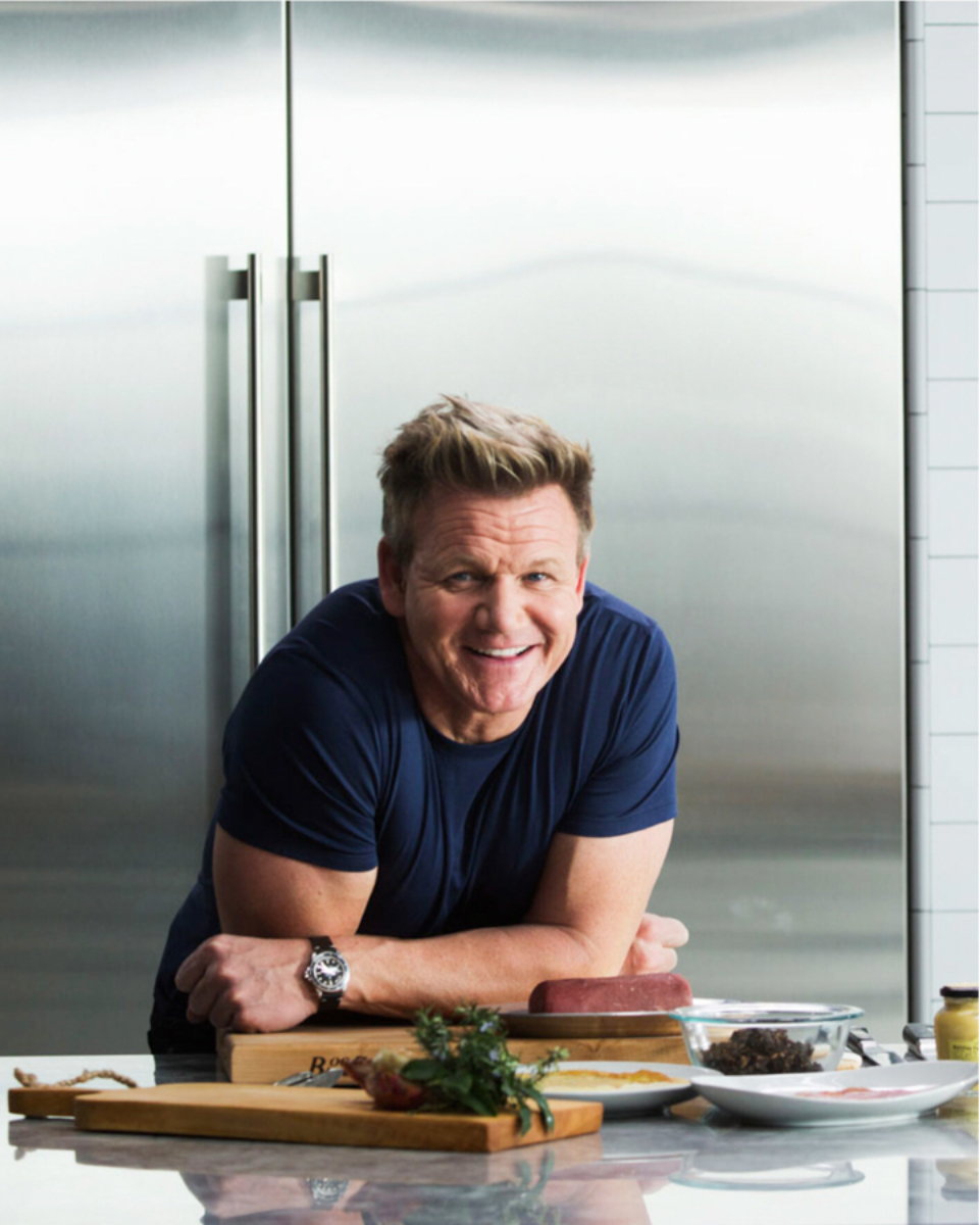 Portrait of Gordon Ramsay leaning casually against the countertop in his kitchen creating a vivid depiction of the renowned chef in his culinary domain, photo by Los Angeles celebrity photographer Victoria Wall Harris.
