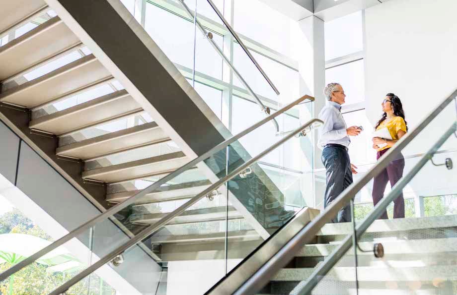 Image of two figures conversing on staircase, by Philadelphia corporate photographer Zave Smith.
