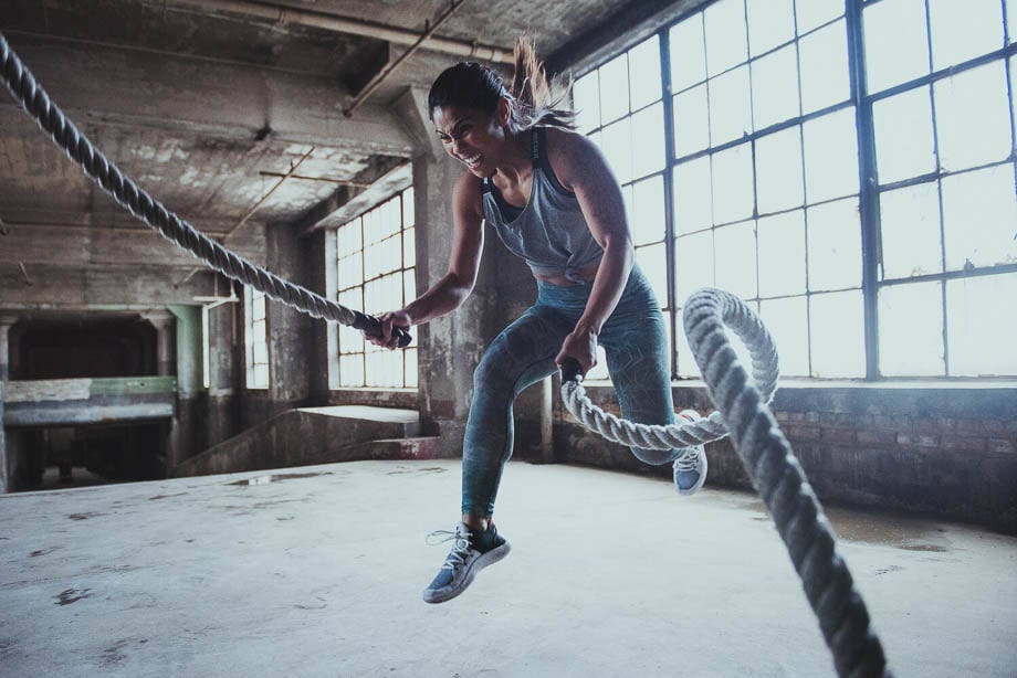 Photo of a woman working out with battle ropes for Nike taken by Chicago-based sports and fitness photographer Zoe Rain. 